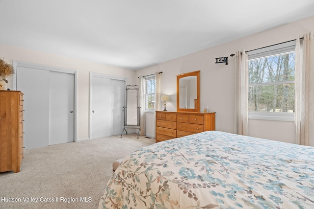 carpeted bedroom with multiple closets