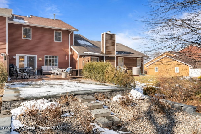 snow covered property featuring cooling unit