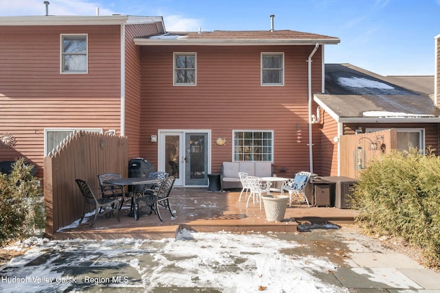 snow covered house featuring a deck