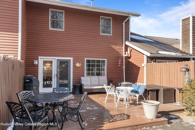 back of house featuring a wooden deck, outdoor lounge area, and french doors