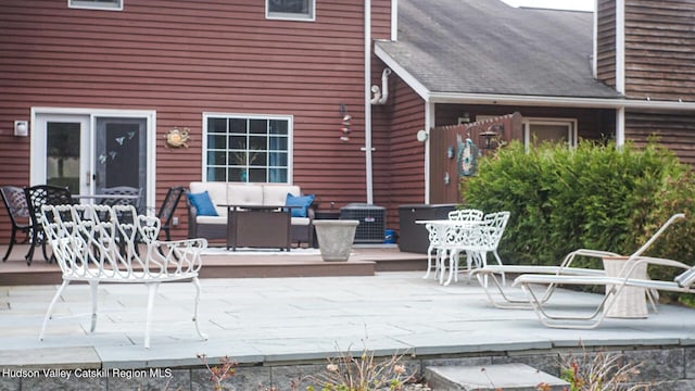 view of patio with outdoor dining area and central AC