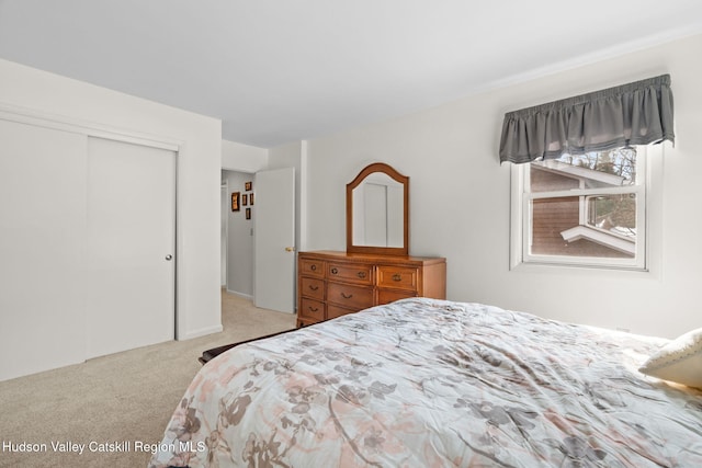 carpeted bedroom featuring a closet