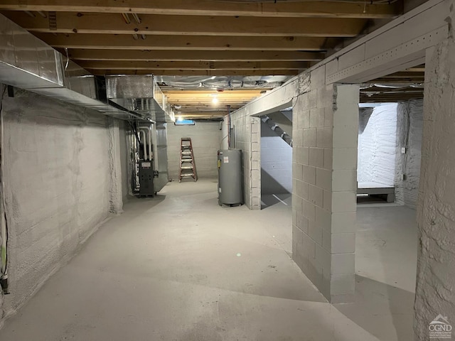 unfinished below grade area featuring electric water heater and heating unit