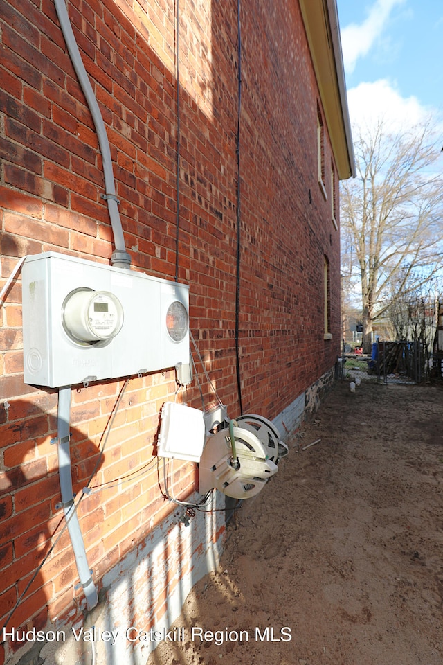 view of side of home with brick siding and crawl space