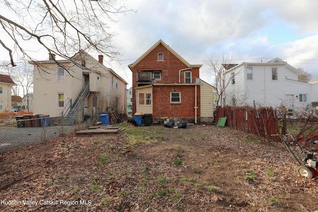 back of house featuring fence