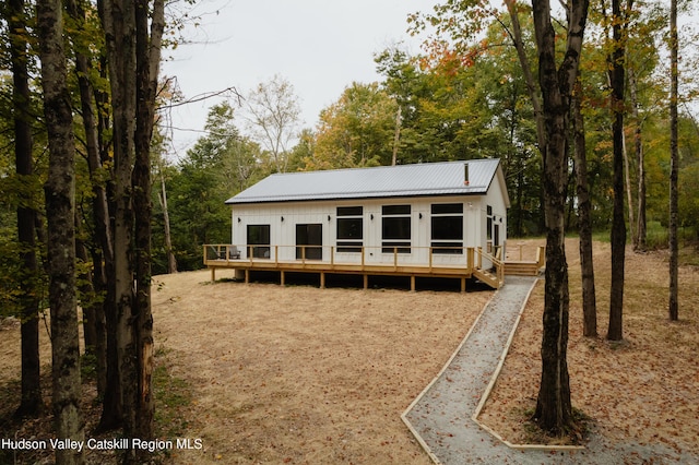 back of house featuring a wooden deck