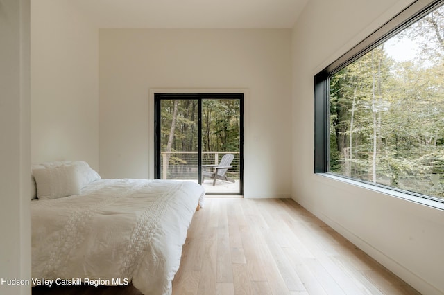 unfurnished bedroom featuring light hardwood / wood-style floors and access to outside