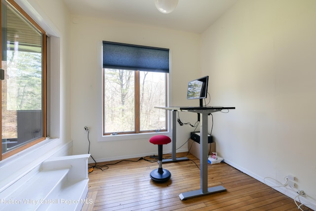 workout room featuring hardwood / wood-style floors and baseboards
