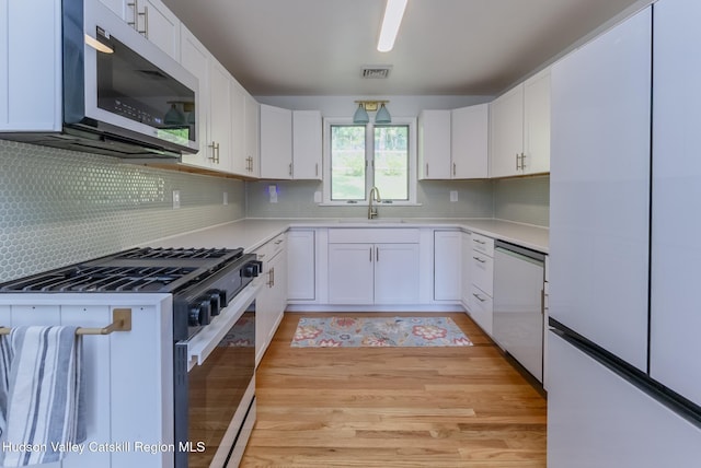 331 Joys Ln, Hurley, NY 12443 - kitchen with stainless steel appliances, light countertops, white cabinets, and backsplash