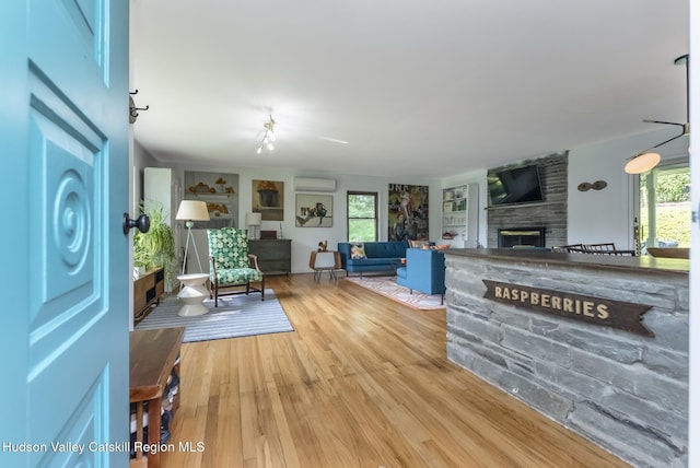 331 Joys Ln, Hurley, NY 12443 - living area featuring a large fireplace, wood finished floors, and plenty of natural light