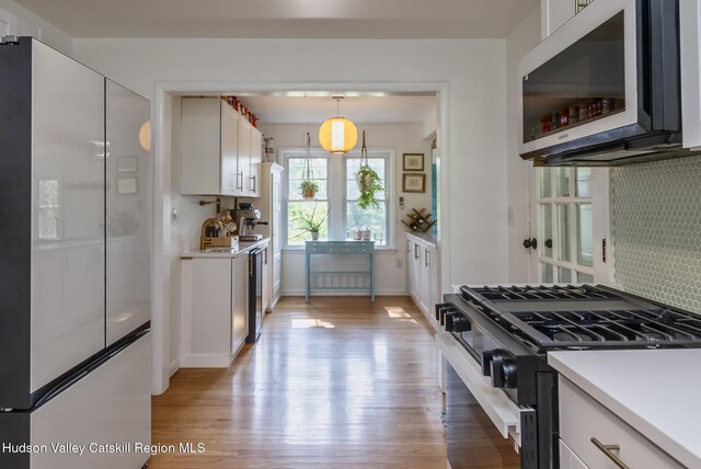 331 Joys Ln, Hurley, NY 12443 - kitchen featuring gas range, freestanding refrigerator, white cabinets, light wood finished floors, and light countertops