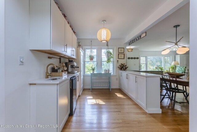 331 Joys Ln, Hurley, NY 12443 - kitchen featuring light countertops, white cabinetry, wine cooler, and a peninsula