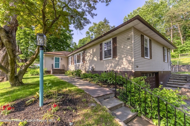 331 Joys Ln, Hurley, NY 12443 - view of front facade with an attached garage, stairway, and a front yard