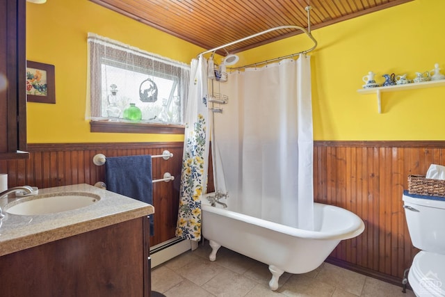470 W Main St, Catskill, NY 12414 - full bath with a wainscoted wall, wooden walls, tile patterned floors, toilet, and a baseboard heating unit