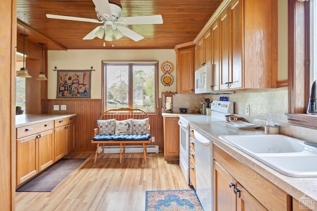 470 W Main St, Catskill, NY 12414 - kitchen with a baseboard radiator, white appliances, wooden ceiling, light countertops, and a wainscoted wall