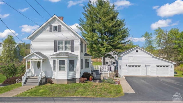 470 W Main St, Catskill, NY 12414 - traditional-style house featuring a chimney, an outbuilding, a front yard, and a garage