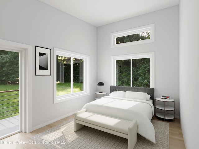 bedroom featuring access to exterior and light hardwood / wood-style floors