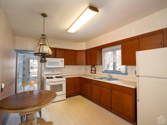 16 Oakwood Blvd, Hudson, NY 12534 - kitchen featuring white appliances, a sink, light countertops, light flooring, and brown cabinetry