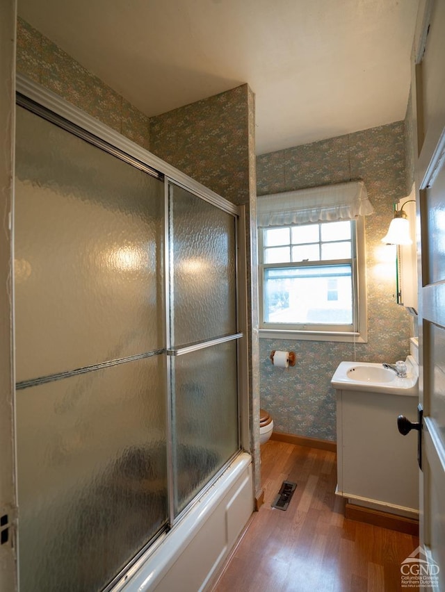 16 Oakwood Blvd, Hudson, NY 12534 - full bath with wood finished floors, vanity, toilet, enclosed tub / shower combo, and wallpapered walls