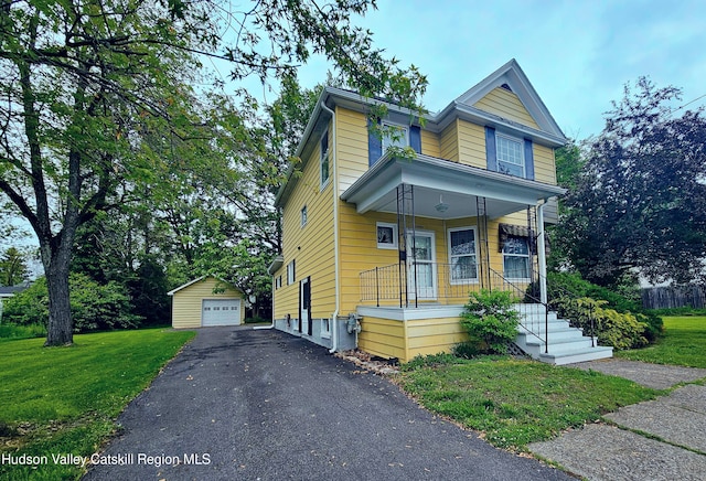 16 Oakwood Blvd, Hudson, NY 12534 - view of front of house with an outdoor structure, covered porch, driveway, a garage, and a front lawn