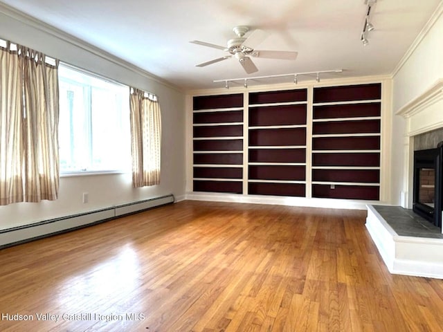 unfurnished living room with ceiling fan, baseboard heating, a tile fireplace, and wood-type flooring