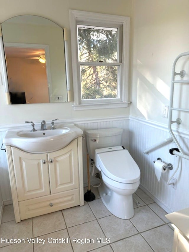 bathroom with ceiling fan, tile patterned floors, toilet, and vanity