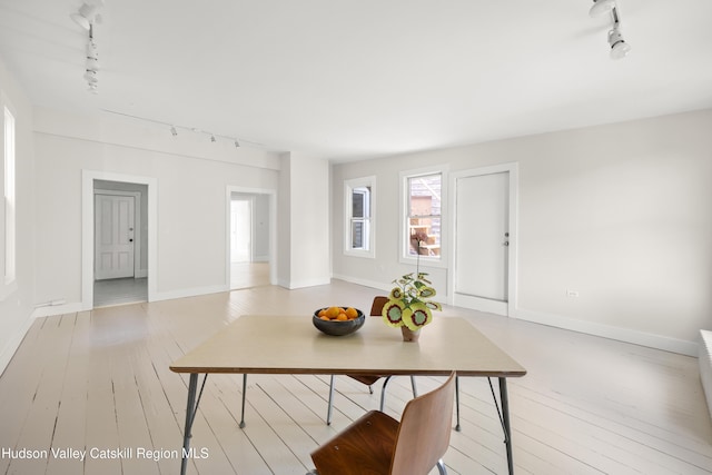 356 Warren St, Hudson, NY 12534 - dining space featuring rail lighting and light wood-style flooring