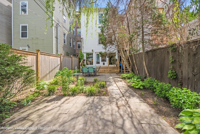 356 Warren St, Hudson, NY 12534 - fenced backyard with a patio and stairway