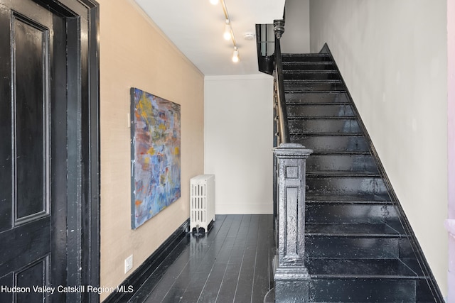 356 Warren St, Hudson, NY 12534 - stairs featuring wood finished floors, track lighting, and radiator heating unit
