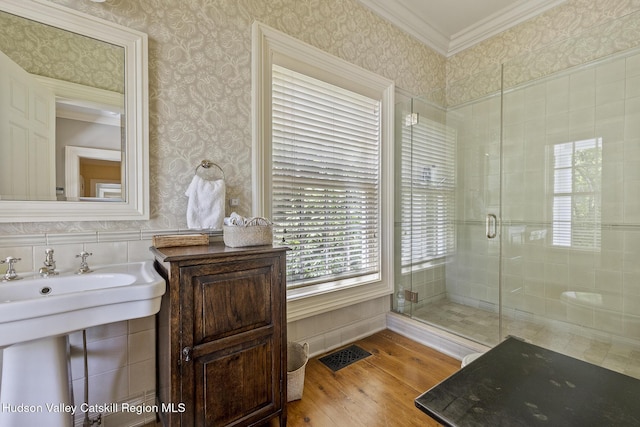 147 Moadock Rd, Millerton, NY 12546 - bathroom with wood finished floors, crown molding, a shower stall, wallpapered walls, and wainscoting