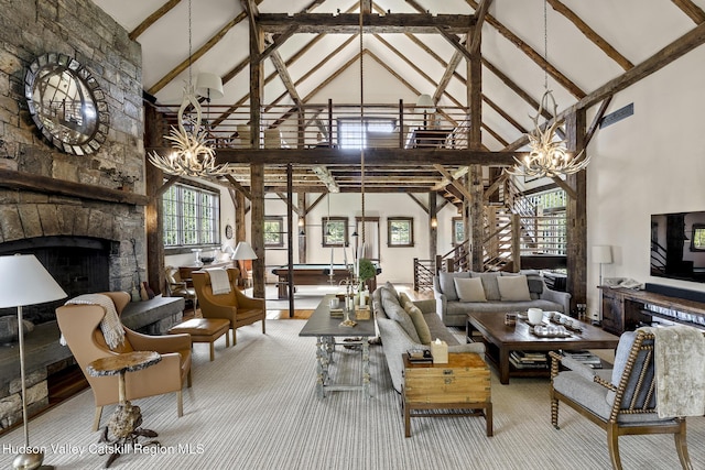 147 Moadock Rd, Millerton, NY 12546 - living area featuring a chandelier, high vaulted ceiling, a stone fireplace, beamed ceiling, and carpet