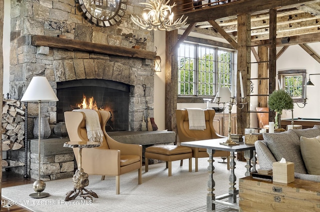 147 Moadock Rd, Millerton, NY 12546 - living area featuring a stone fireplace, healthy amount of natural light, and a chandelier