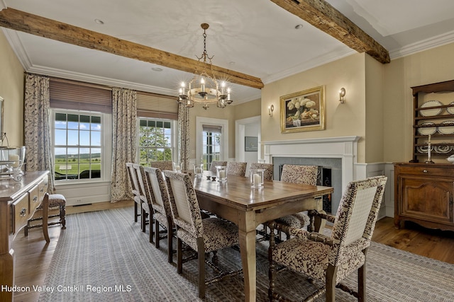 147 Moadock Rd, Millerton, NY 12546 - dining room with beam ceiling, wood finished floors, crown molding, a chandelier, and a fireplace