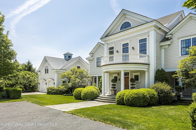 147 Moadock Rd, Millerton, NY 12546 - greek revival inspired property featuring a balcony, a front lawn, and a porch