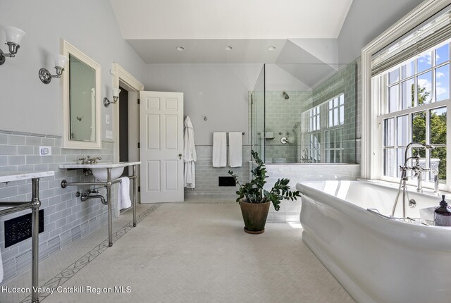 147 Moadock Rd, Millerton, NY 12546 - bathroom with tile walls, a freestanding bath, tiled shower, and a wainscoted wall