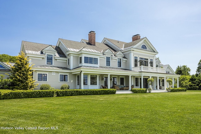 147 Moadock Rd, Millerton, NY 12546 - view of front of home with a standing seam roof, covered porch, a front yard, a metal roof, and a balcony