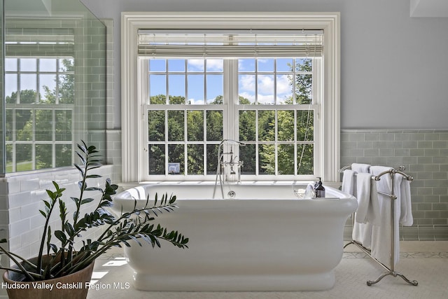 147 Moadock Rd, Millerton, NY 12546 - bathroom with tile walls, plenty of natural light, and a freestanding tub