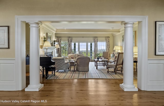 147 Moadock Rd, Millerton, NY 12546 - living room with decorative columns, crown molding, plenty of natural light, wainscoting, and a decorative wall