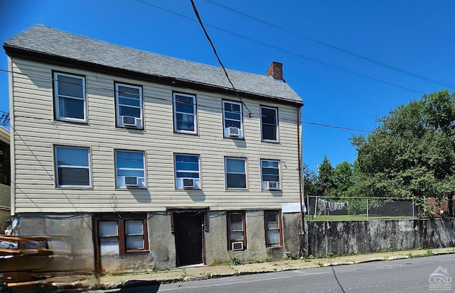 233-235 Columbia St, Hudson, NY 12534 - view of front facade featuring fence, a chimney, and cooling unit