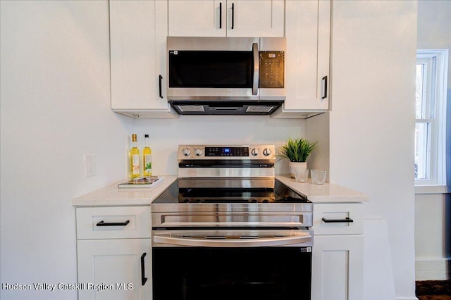kitchen featuring light countertops, white cabinets, and stainless steel appliances