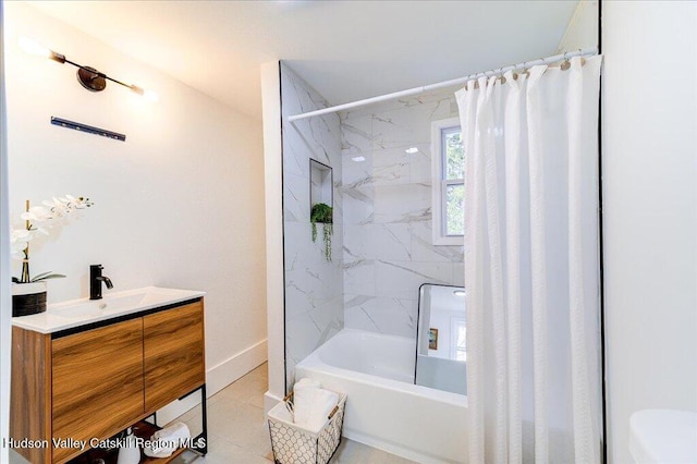 bathroom featuring tile patterned flooring, shower / bath combo, vanity, toilet, and baseboards