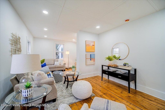 living area with recessed lighting, baseboards, and hardwood / wood-style flooring