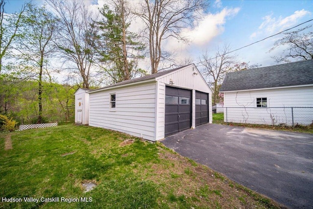 detached garage featuring fence