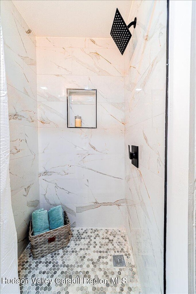 bathroom with tiled shower