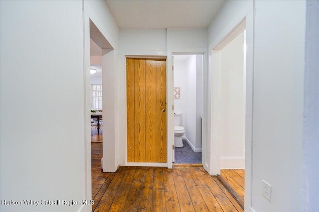 corridor with hardwood / wood-style floors