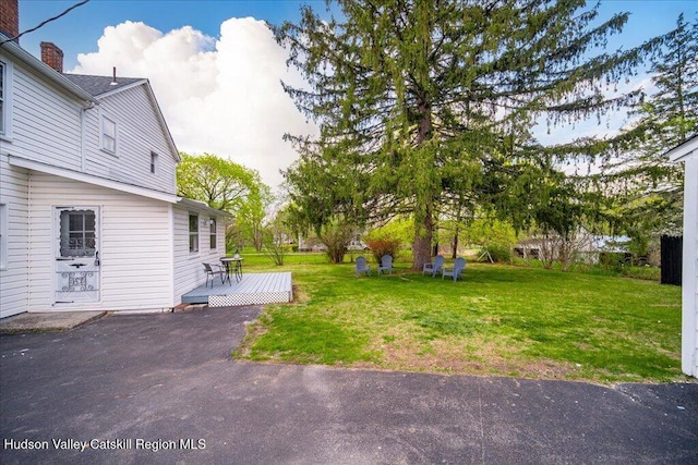 view of yard featuring a wooden deck