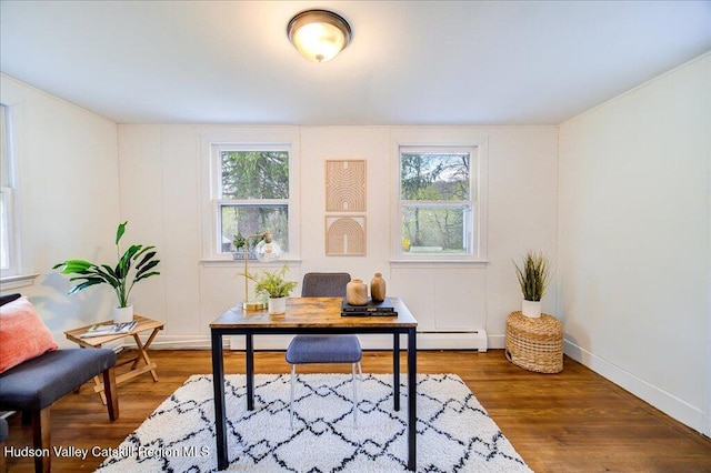 office area with baseboards, a wealth of natural light, and wood finished floors