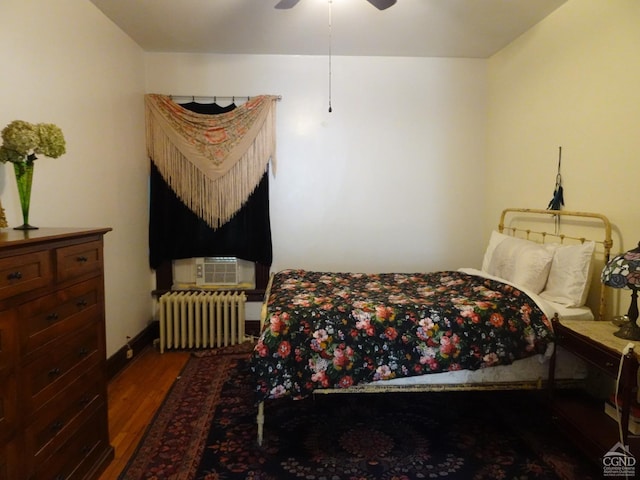 32-34 8th St, Hudson, NY 12534 - bedroom featuring radiator heating unit, wood finished floors, cooling unit, and ceiling fan