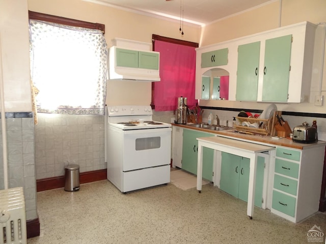32-34 8th St, Hudson, NY 12534 - kitchen featuring white electric range oven, a sink, radiator heating unit, tile walls, and green cabinetry