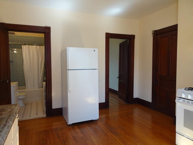 32-34 8th St, Hudson, NY 12534 - kitchen featuring white appliances, dark wood-style flooring, and baseboards
